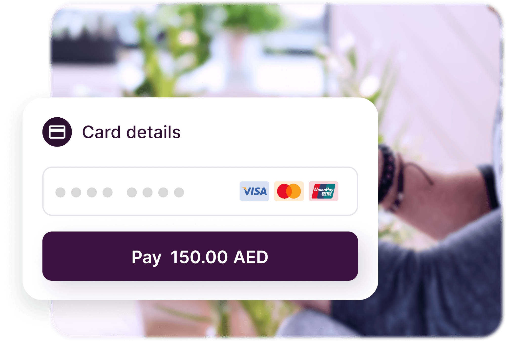 A card details field with a pay button over an image of a person holding a phone